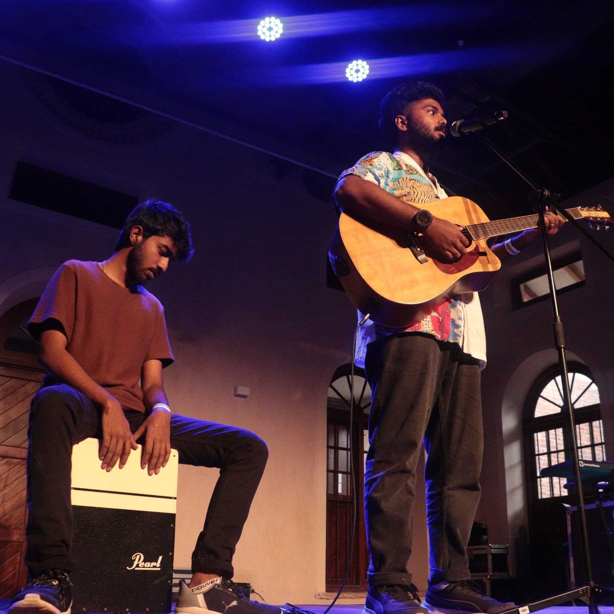 Ajay Nathan performing under stage lights at Sabha, Bangalore