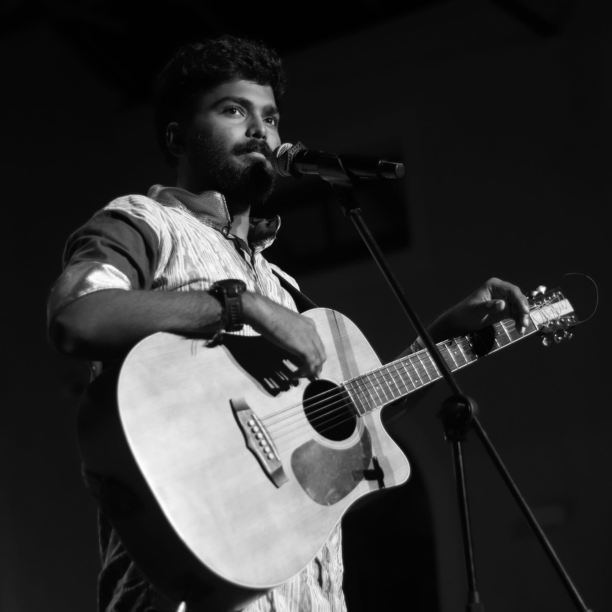 Ajay Nathan mid-performance, black and white